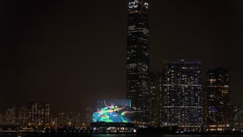 Screenshot of Touch for Luck on the M+ facade at night